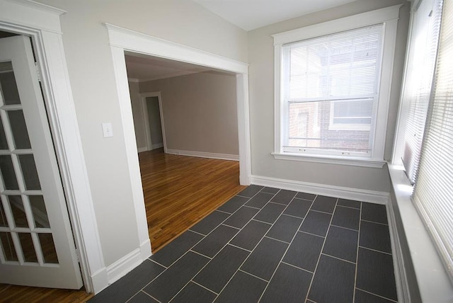 701 Limit Ave, University City, MO 63130 - unfurnished room with plenty of natural light, baseboards, and dark tile patterned floors