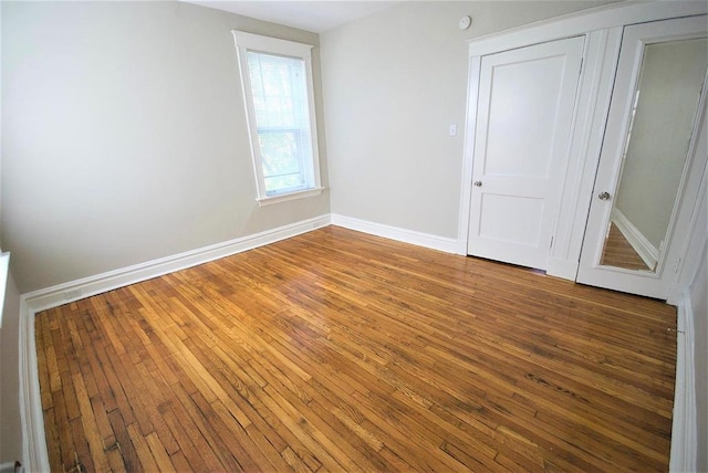 701 Limit Ave, University City, MO 63130 - unfurnished bedroom featuring hardwood / wood-style flooring and baseboards