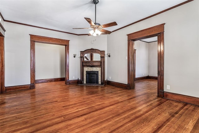 305 W 1st St, Farmington, MO 63640 - unfurnished living room featuring a fireplace with flush hearth, wood finished floors, a ceiling fan, crown molding, and baseboards