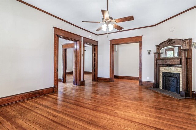 305 W 1st St, Farmington, MO 63640 - unfurnished living room with baseboards, a fireplace, wood finished floors, a ceiling fan, and ornamental molding