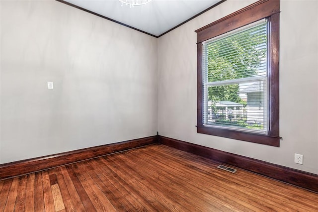 305 W 1st St, Farmington, MO 63640 - spare room featuring plenty of natural light, baseboards, ornamental molding, and hardwood / wood-style flooring