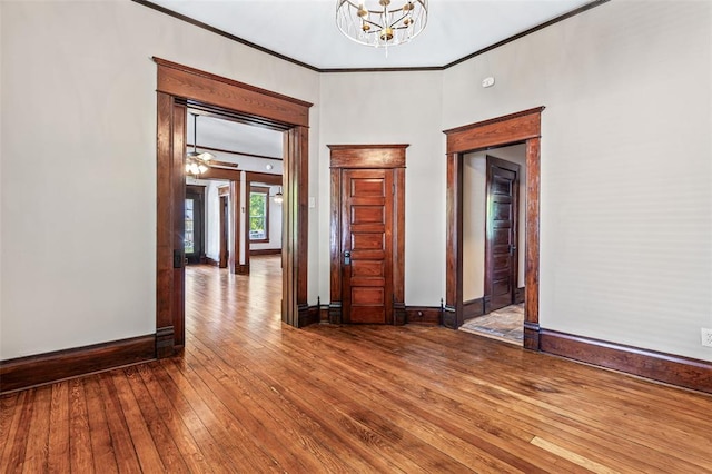 305 W 1st St, Farmington, MO 63640 - empty room with crown molding, hardwood / wood-style flooring, a chandelier, and baseboards
