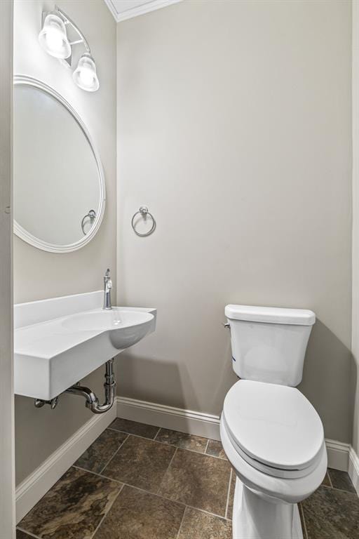 305 W 1st St, Farmington, MO 63640 - half bath with baseboards, toilet, stone tile floors, and ornamental molding
