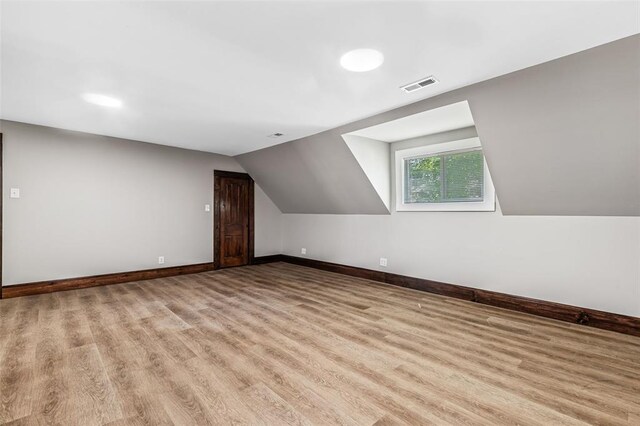 305 W 1st St, Farmington, MO 63640 - additional living space with wood finished floors, baseboards, and lofted ceiling