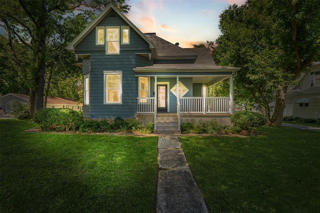 305 W 1st St, Farmington, MO 63640 - view of front of home with covered porch, a front lawn, and a shingled roof