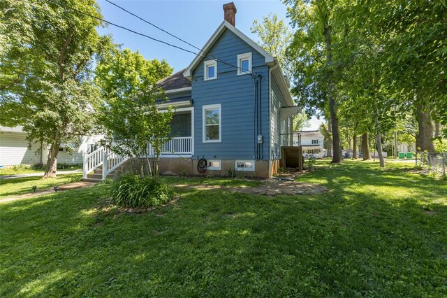 305 W 1st St, Farmington, MO 63640 - view of home's exterior with a chimney and a yard