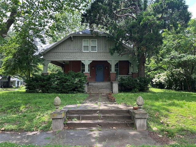 301 N Everett St, Kennett, MO 63857 - bungalow-style home featuring covered porch, a front lawn, and brick siding