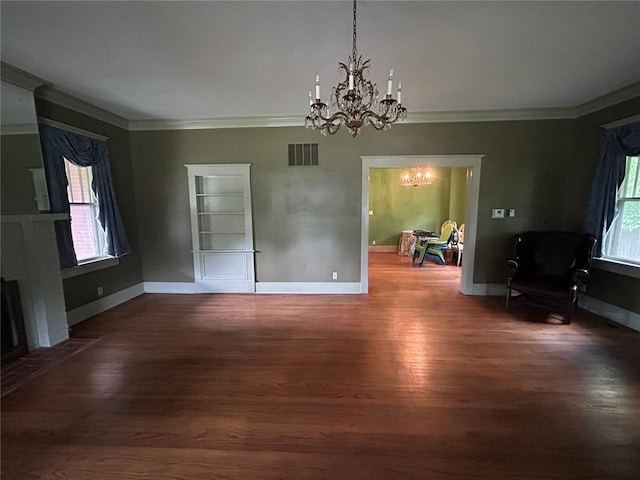 301 N Everett St, Kennett, MO 63857 - unfurnished dining area featuring a chandelier, ornamental molding, wood finished floors, and healthy amount of natural light
