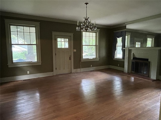 301 N Everett St, Kennett, MO 63857 - unfurnished living room with a chandelier, wood finished floors, crown molding, a fireplace, and baseboards
