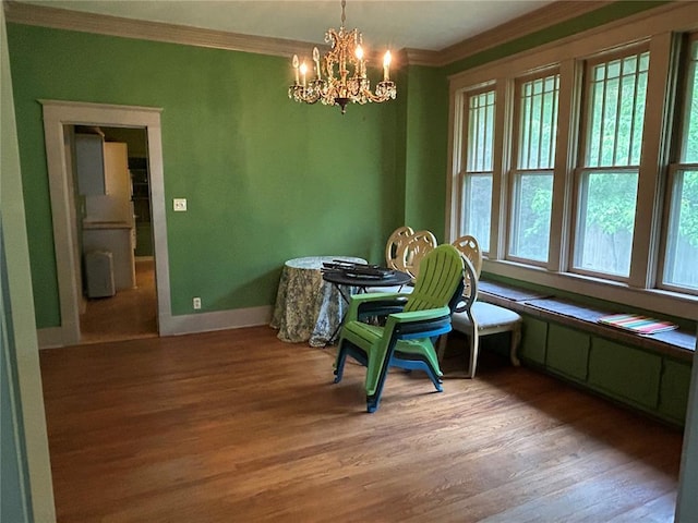 301 N Everett St, Kennett, MO 63857 - dining area featuring crown molding, light wood-type flooring, a chandelier, and baseboards