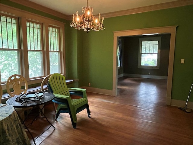 301 N Everett St, Kennett, MO 63857 - living area featuring ornamental molding, baseboards, wood finished floors, and a chandelier