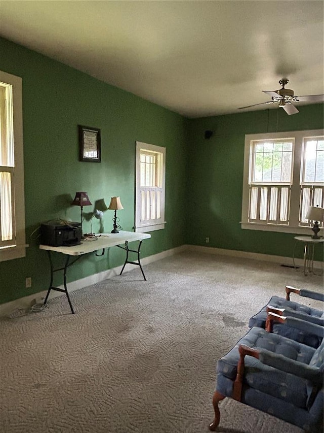 301 N Everett St, Kennett, MO 63857 - unfurnished living room with carpet floors, ceiling fan, and baseboards