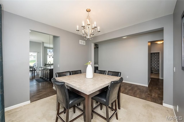 1510 Kennabrooke Ct, Saint Louis, MO 63146 - dining room featuring a chandelier, light wood-style flooring, and light colored carpet
