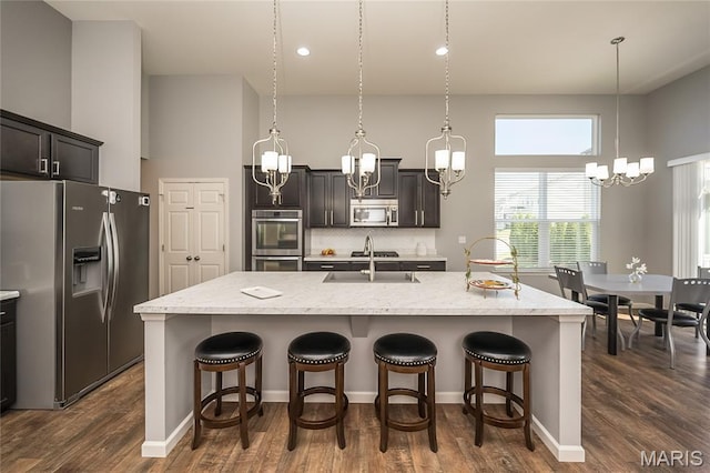 1510 Kennabrooke Ct, Saint Louis, MO 63146 - kitchen featuring stainless steel appliances, a chandelier, a kitchen breakfast bar, a kitchen island with sink, and recessed lighting