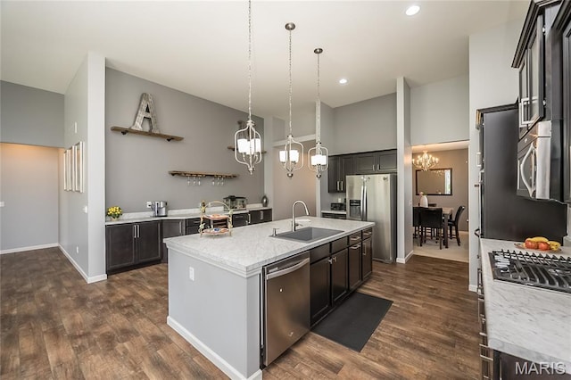 1510 Kennabrooke Ct, Saint Louis, MO 63146 - kitchen with stainless steel appliances, a chandelier, open shelves, a center island with sink, and dark wood-type flooring