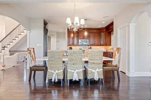 5360 Tower Hill Ct, Weldon Spring, MO 63304 - dining space featuring arched walkways, a chandelier, baseboards, recessed lighting, and dark wood-style floors