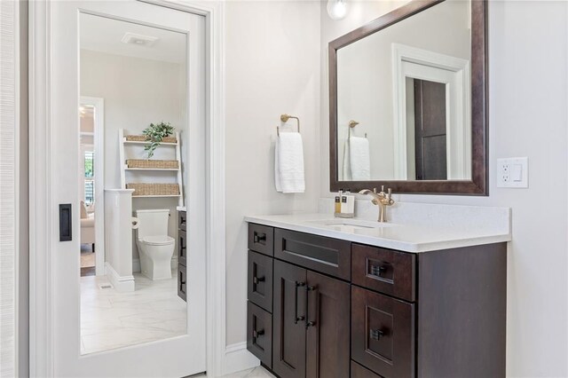 5360 Tower Hill Ct, Weldon Spring, MO 63304 - bathroom featuring vanity, toilet, baseboards, and marble finish floors