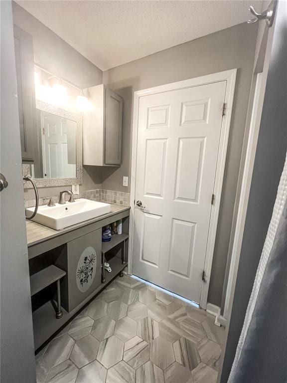 408 E Monroe St, Paris, MO 65275 - bathroom with vanity and a textured ceiling
