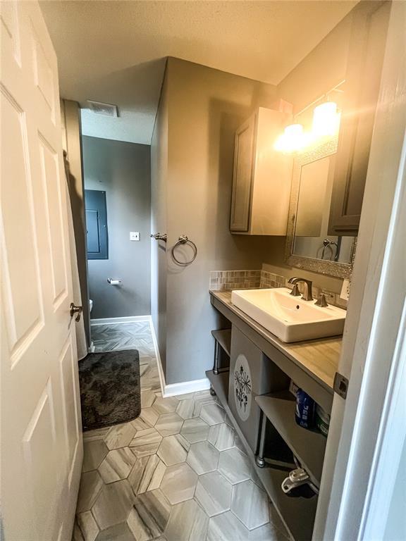 408 E Monroe St, Paris, MO 65275 - half bath with baseboards, toilet, and vanity