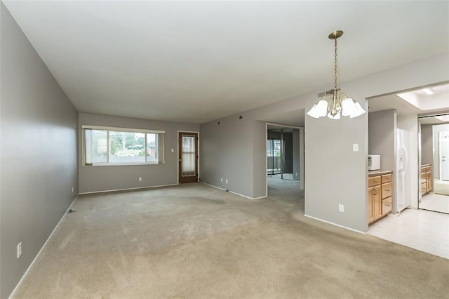 2 Fairways Cir Unit G, Saint Charles, MO 63303 - empty room featuring a chandelier, light carpet, and baseboards