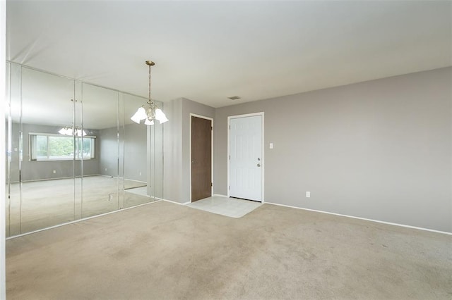 2 Fairways Cir Unit G, Saint Charles, MO 63303 - empty room featuring a chandelier, carpet flooring, and baseboards