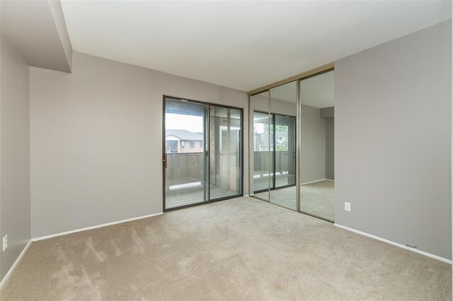 2 Fairways Cir Unit G, Saint Charles, MO 63303 - spare room featuring carpet and baseboards