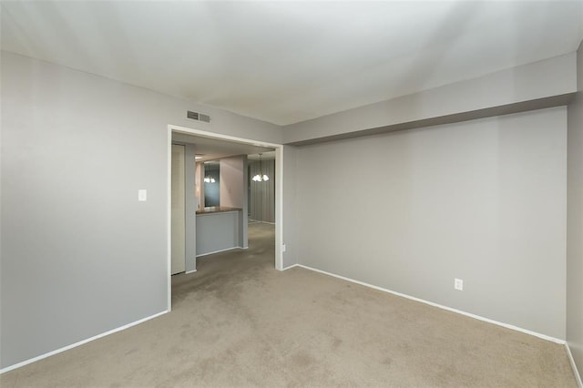 2 Fairways Cir Unit G, Saint Charles, MO 63303 - carpeted spare room featuring baseboards and a chandelier