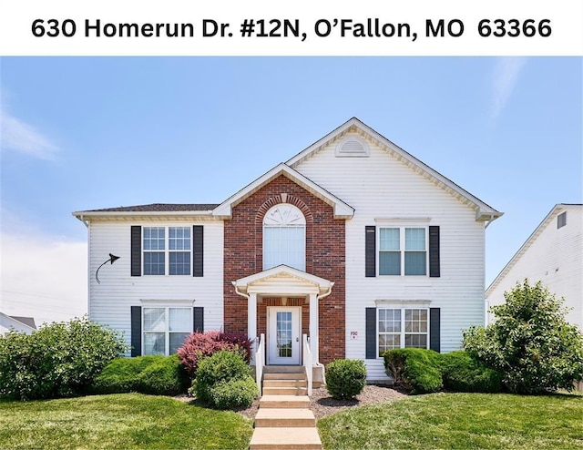 630 Homerun Dr Unit 12N, Ofallon, MO 63366 - view of front facade featuring a front yard and brick siding