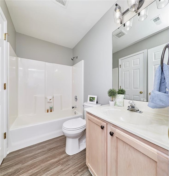 630 Homerun Dr Unit 12N, Ofallon, MO 63366 - full bathroom featuring wood finished floors, vanity, washtub / shower combination, and toilet