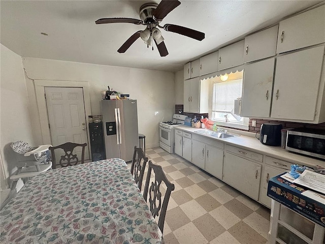 155 W Bonfils St, Troy, MO 63379 - kitchen featuring stainless steel appliances, a sink, light countertops, light floors, and ceiling fan