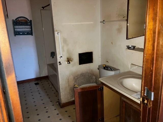 506 W Main St, Matthews, MO 63867 - bathroom featuring tile patterned floors, vanity, and baseboards