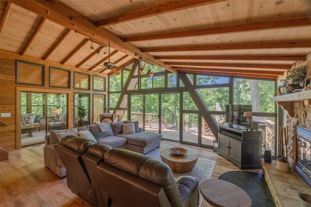 2349 Trautwein Dr, Innsbrook, MO 63390 - living area with a stone fireplace, light wood finished floors, a ceiling fan, high vaulted ceiling, and wooden ceiling with exposed beams