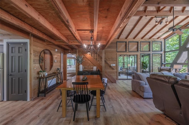 2349 Trautwein Dr, Innsbrook, MO 63390 - dining room featuring wood walls, light wood-type flooring, a chandelier, and wooden ceiling with exposed beams
