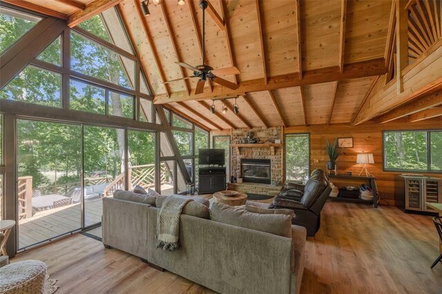 2349 Trautwein Dr, Innsbrook, MO 63390 - living area with high vaulted ceiling, a fireplace, wood finished floors, wooden walls, and wood ceiling with exposed beams