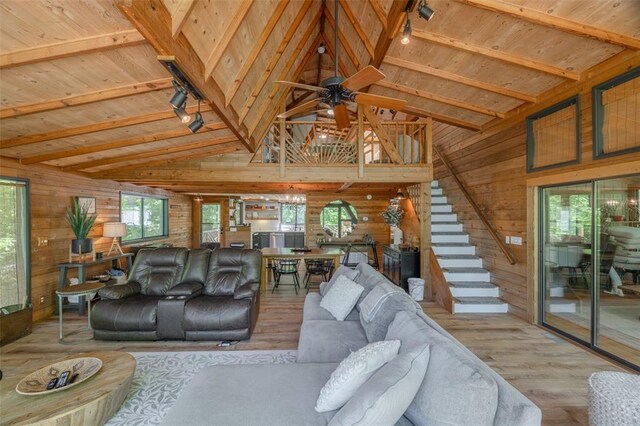 2349 Trautwein Dr, Innsbrook, MO 63390 - living room with wood finished floors, wooden walls, a ceiling fan, stairs, and wood ceiling