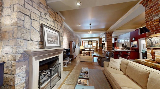 1107 N 2nd St, Saint Charles, MO 63301 - living room with a fireplace, wood finished floors, and decorative columns