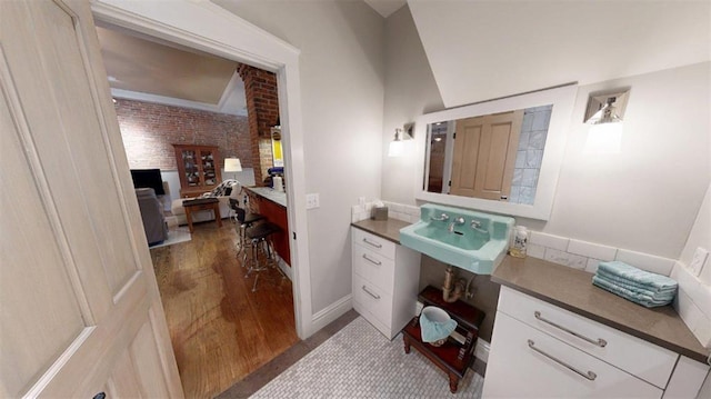 1107 N 2nd St, Saint Charles, MO 63301 - bathroom featuring a sink and wood finished floors