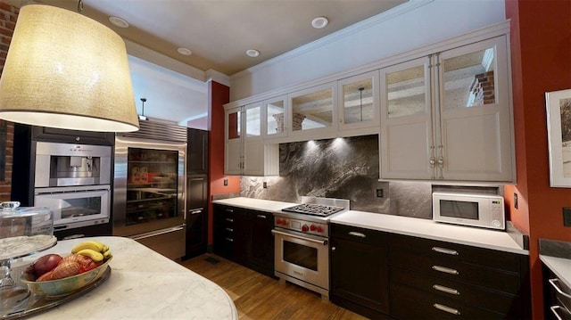 1107 N 2nd St, Saint Charles, MO 63301 - kitchen with high quality appliances, light countertops, dark wood finished floors, tasteful backsplash, and glass insert cabinets