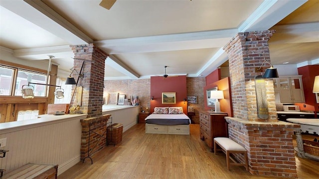 1107 N 2nd St, Saint Charles, MO 63301 - bedroom with ornate columns, wood finished floors, beamed ceiling, and brick wall