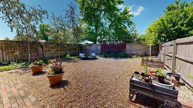 1107 N 2nd St, Saint Charles, MO 63301 - fenced backyard with a patio area and a vegetable garden