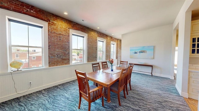 1107 N 2nd St, Saint Charles, MO 63301 - dining room with carpet flooring, recessed lighting, baseboards, and brick wall