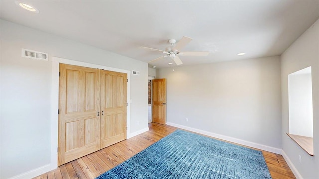 1107 N 2nd St, Saint Charles, MO 63301 - unfurnished bedroom with light wood-style flooring, baseboards, recessed lighting, a ceiling fan, and a closet