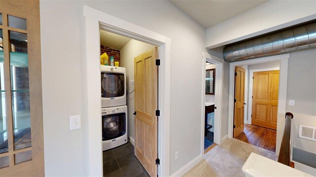1107 N 2nd St, Saint Charles, MO 63301 - laundry room featuring stacked washing machine and dryer and baseboards