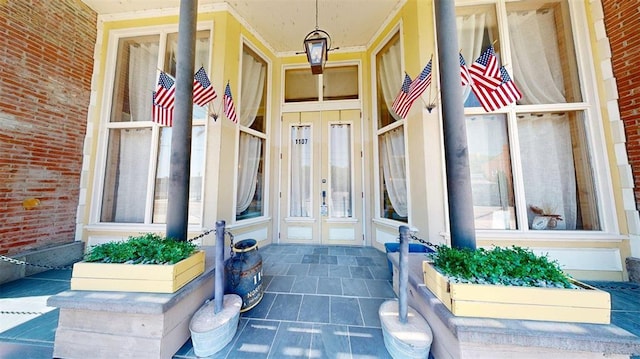 1107 N 2nd St, Saint Charles, MO 63301 - view of exterior entry featuring french doors and a porch