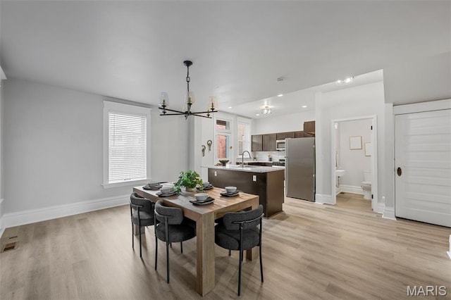 6014 Westminster Pl, Saint Louis, MO 63112 - dining space featuring a chandelier, baseboards, light wood-style floors, and recessed lighting