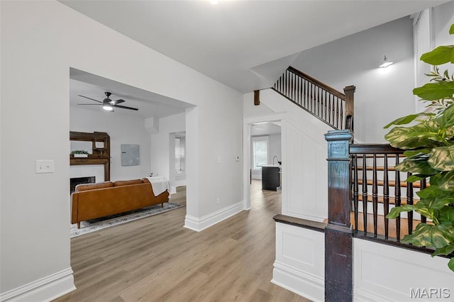 6014 Westminster Pl, Saint Louis, MO 63112 - hallway featuring light wood-style floors, stairway, and baseboards