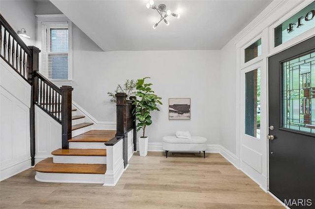6014 Westminster Pl, Saint Louis, MO 63112 - entrance foyer featuring stairs, light wood-style floors, and baseboards