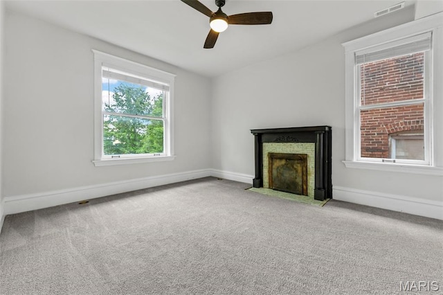 6014 Westminster Pl, Saint Louis, MO 63112 - unfurnished living room with a fireplace with flush hearth, carpet, a ceiling fan, and baseboards