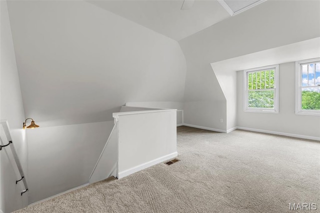 6014 Westminster Pl, Saint Louis, MO 63112 - additional living space with vaulted ceiling, carpet floors, and baseboards