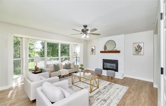 7219 Watsons Parish Dr, Ofallon, MO 63368 - living area with ceiling fan, a fireplace, baseboards, and wood finished floors
